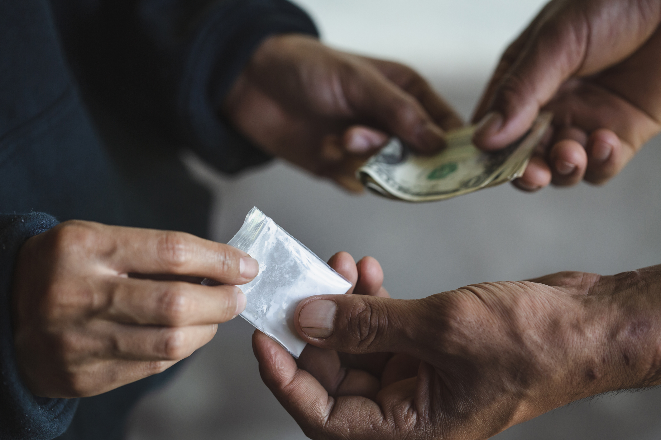 addict buying dose from drug dealer