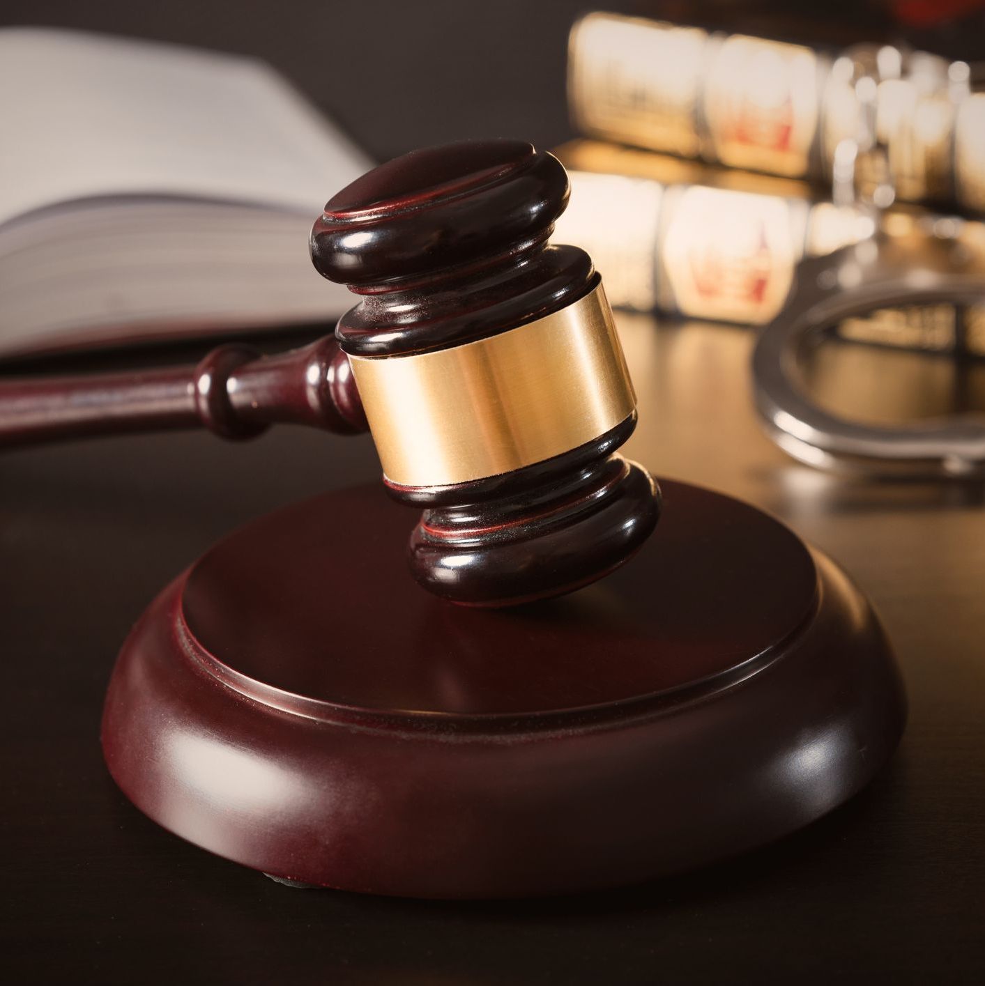 Judge gavel in court. Legal and justice concept. Library, books and handcuffs